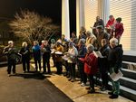 people singing on a the Ivy Glenn Memorial's front steps