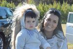 a woman holds a child in a porcupine costume