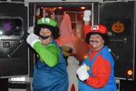 two people in Mario Brothers' costumes behind an open ambulance