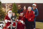several people with Santa and Mrs. Claus