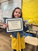 a child posing with an award