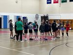 a group of children and adults in a gym