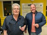 two men posing with award pins