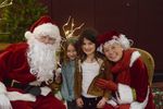 two children with Santa and Mrs. Claus