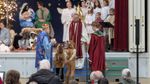 men dressed as the magi in front of the ohter cast members
