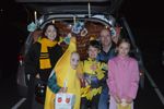 a group of people in costumes with their trunk open