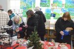 several people looking at a table of baked goods