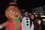 a person in a gingerbread costume with someone in a snowman costume and one person with no costume