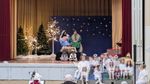 children dressed as angels in front of adults dressed as Mary and Joseph with a baby and two children dressed as animals