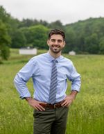 Ethan Werstler wearing a tie standing in a field