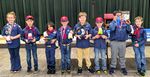 several cub scouts posing with homemade toy boats