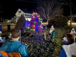 two people by a Christmas tree