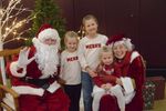 three children with Santa and Mrs. Claus