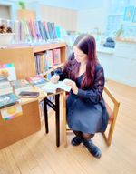 a woman signs books